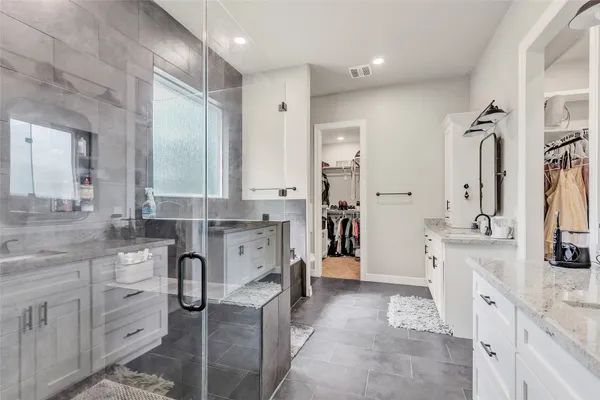 a bathroom with a tub sink and mirror