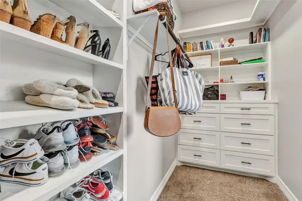 a view of walk in closet with clothes