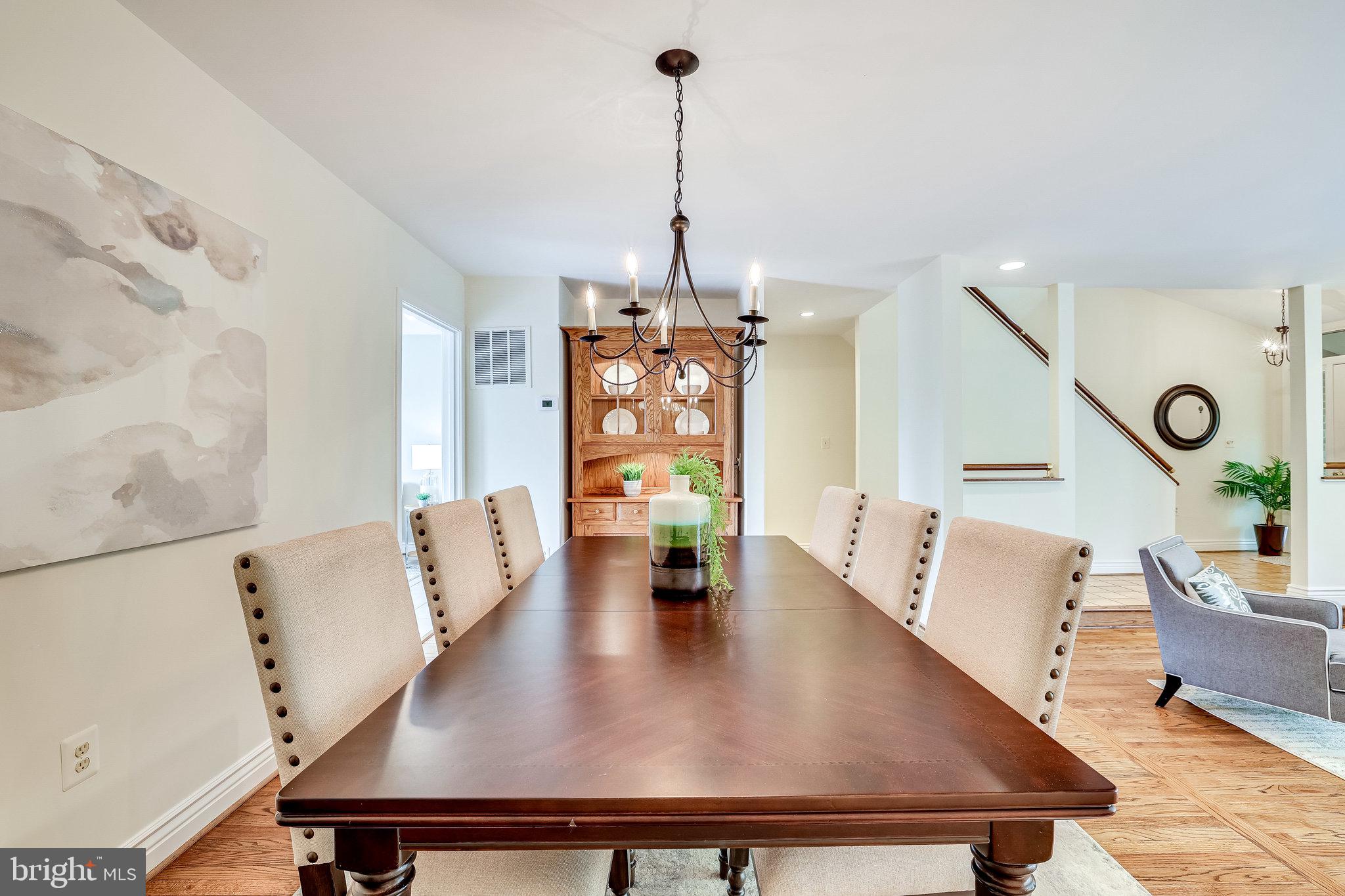 2024 Lakebreeze Way Reston, VA 20191 - Photo 15 of 95 a view of dining room and livingroom with furniture wooden floor a chandelier