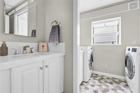 a bathroom with a sink vanity and mirror