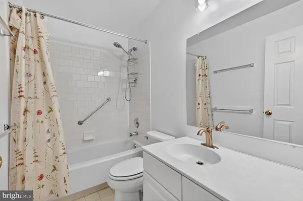 a bathroom with a tub sink and mirror
