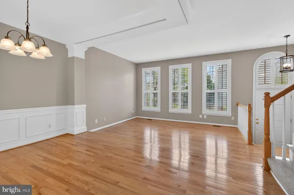 a living room with furniture a rug and wall paintings