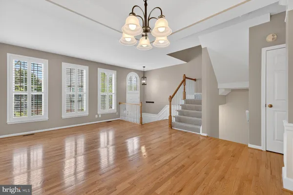 a open kitchen with granite countertop a stove top oven a sink dishwasher and a fireplace with wooden floor