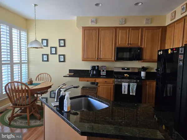a kitchen with a sink stove and microwave