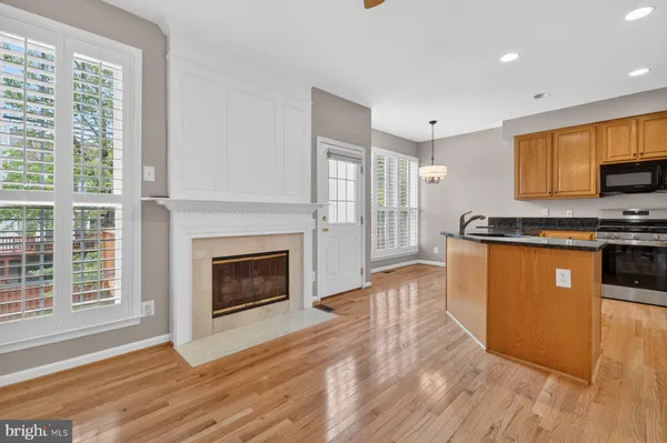 a kitchen with kitchen island granite countertop a sink table and chairs