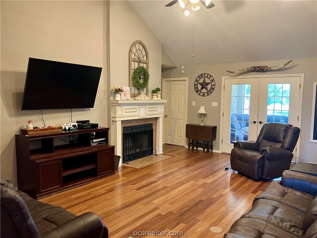 5660 Falling Water Bryan, TX 77808 - Photo 19 of 27 Living room with high vaulted ceiling, french doors, ceiling fan, and light hardwood / wood-style flooring
