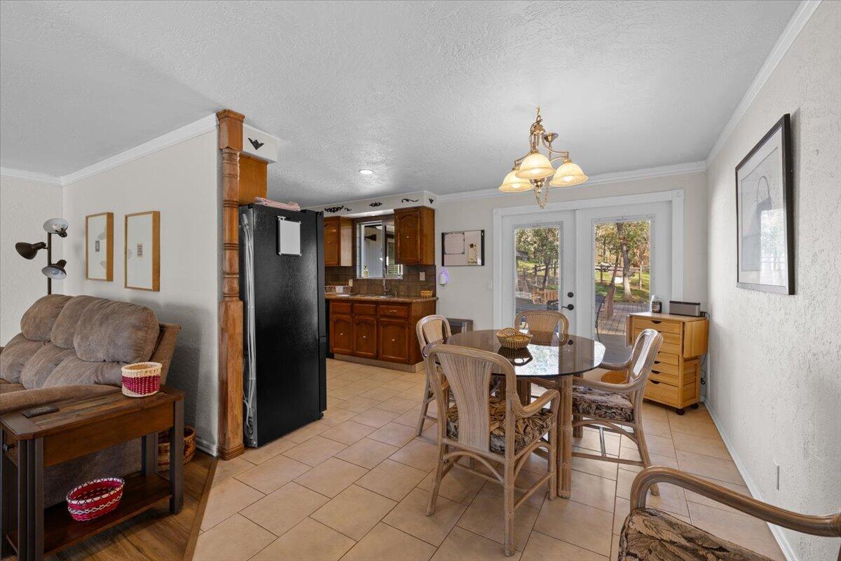 324 China Gulch Road Jacksonville, OR 97530 - Photo 10 of 45 a view of a dining room with furniture window and wooden floor