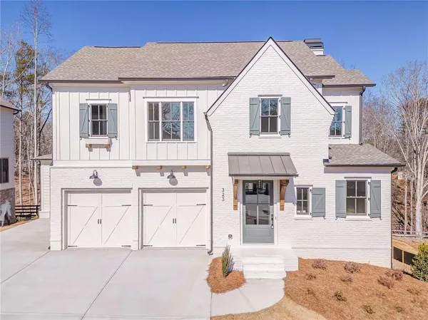 a front view of a house with white walls