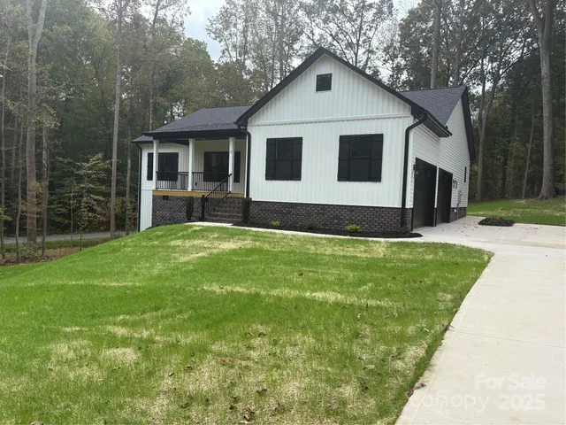 a front view of house with yard and green space