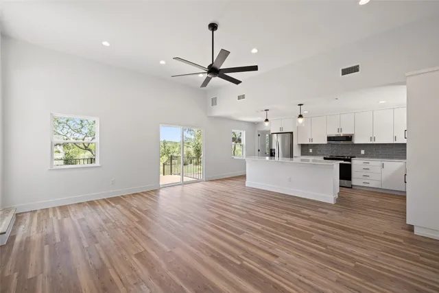 a view of kitchen with refrigerator stove microwave and cabinets