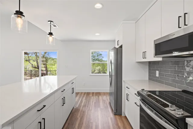 a kitchen with sink cabinets and wooden floor