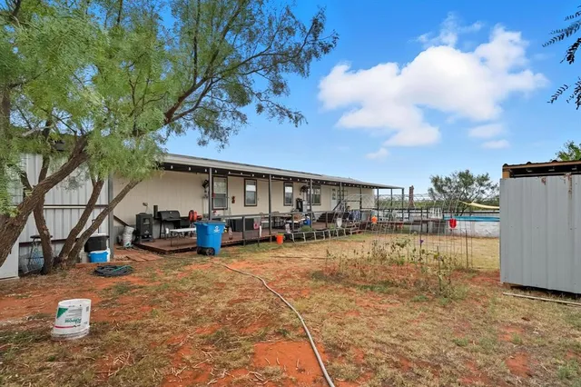 a view of a house with sitting area and a car park