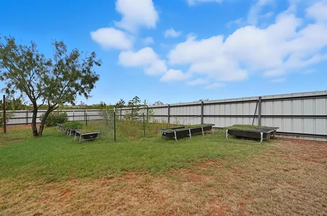 a backyard of a house with barbeque oven and outdoor seating
