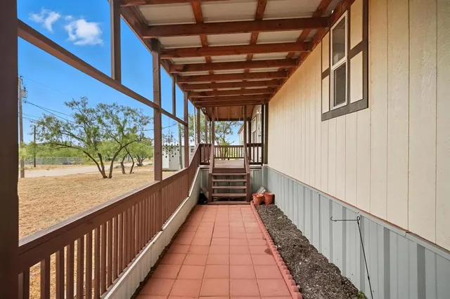 a view of a porch with wooden floor and outdoor space