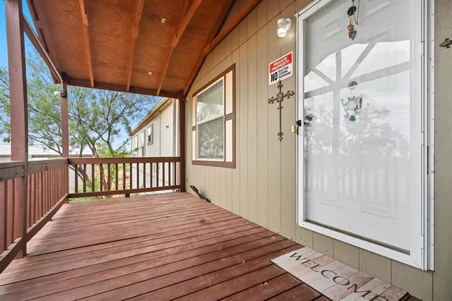 a view of a balcony with wooden floor