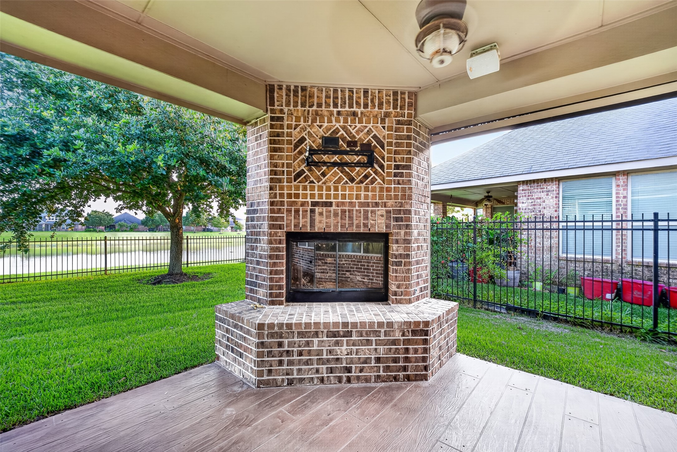 7930 Summer Night Lane Rosenberg, TX 77469 - Photo 39 of 48 Expansive covered patio with a cozy outdoor fireplace overlooking the backyard.