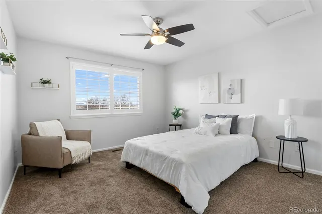 a bedroom with a bed and a couch