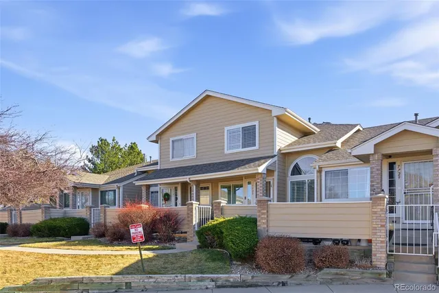 a front view of a house with garden and plants