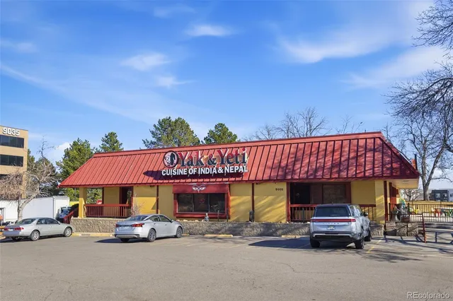 a view of a cars park in front of a building