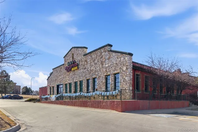 a front view of a house with a road