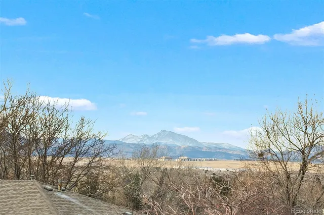 a view of mountain with sunset in background