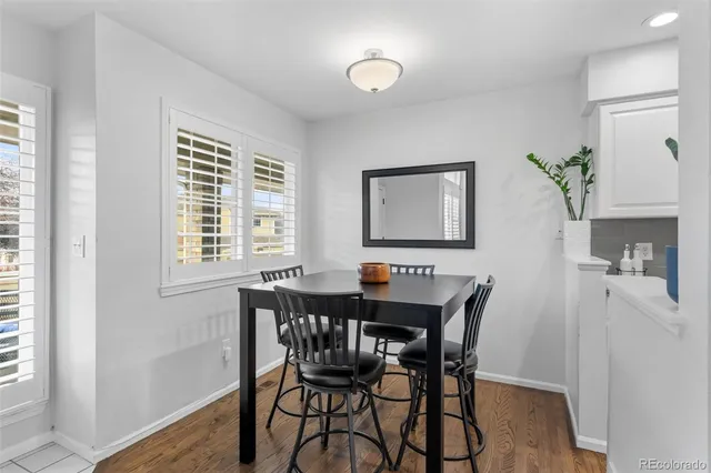 a view of a dining room with furniture and a window