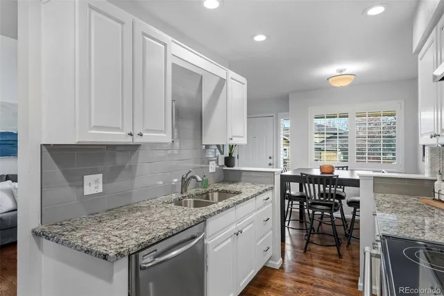 a kitchen with stainless steel appliances granite countertop wooden cabinets and a granite counter tops