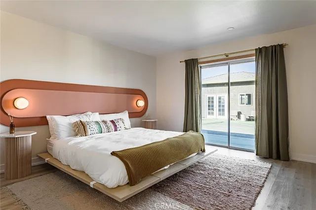 a bedroom with a large bed and a window