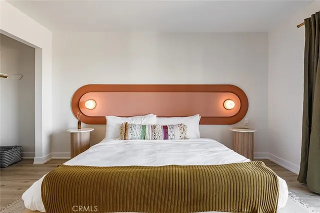 a bedroom with a bed and a window