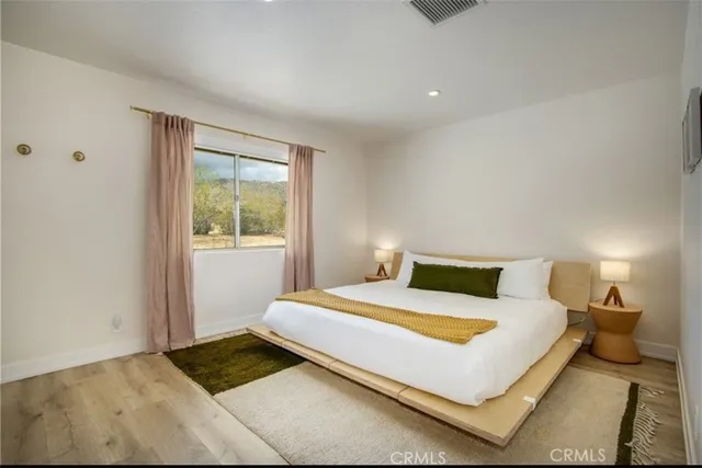 a bedroom with a bed and window