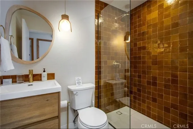 a bathroom with a sink mirror toilet and shower