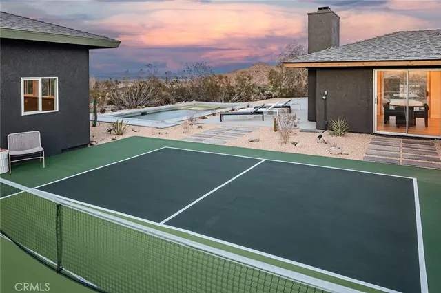 a view of a balcony with two chairs and a potted plant
