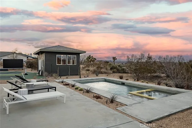 a view of a patio with swimming pool table and chairs