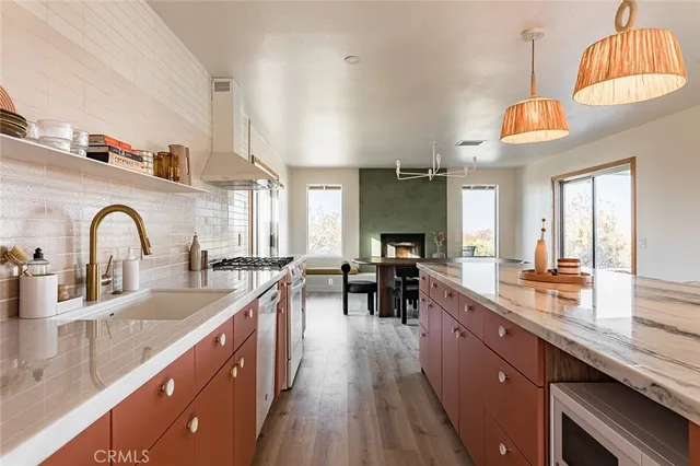 a kitchen with counter top space a sink appliances and cabinets