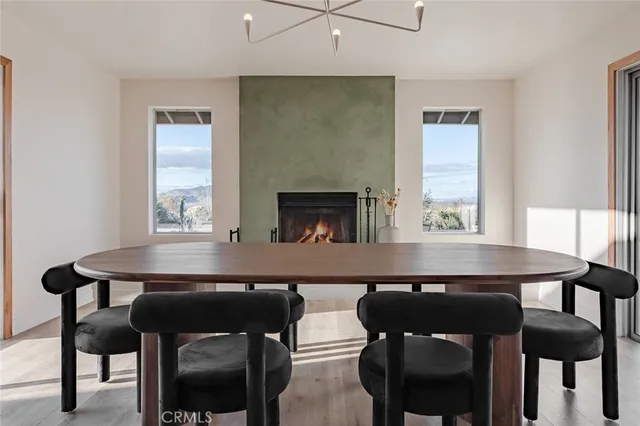 a kitchen with a dining table chairs and a fireplace