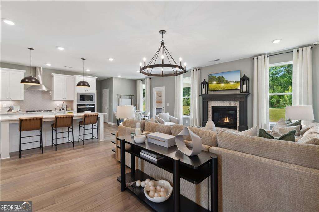 412 Hartsfield Road McDonough, GA 30253 - Photo 11 of 43 a living room with furniture a fireplace and a open kitchen view