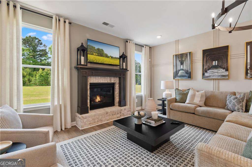 412 Hartsfield Road McDonough, GA 30253 - Photo 13 of 43 a living room with furniture a window and a fireplace