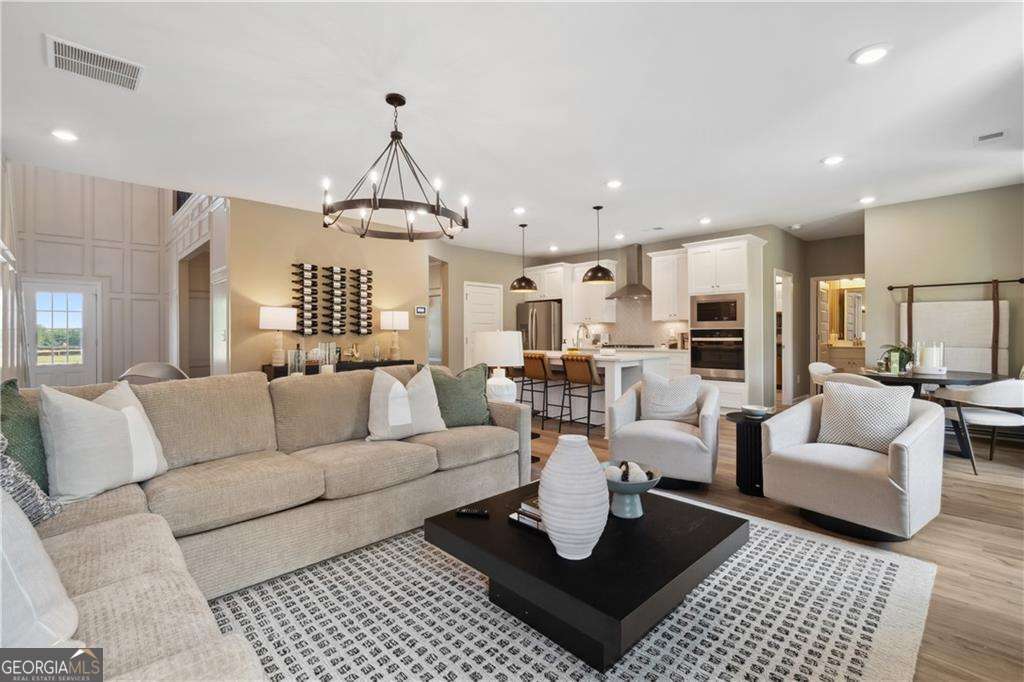 412 Hartsfield Road McDonough, GA 30253 - Photo 14 of 43 a living room with furniture or kitchen and a chandelier