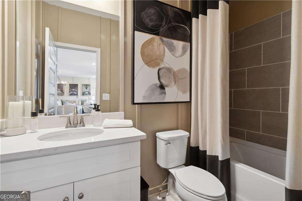 412 Hartsfield Road McDonough, GA 30253 - Photo 21 of 43 a bathroom with a toilet sink and shower