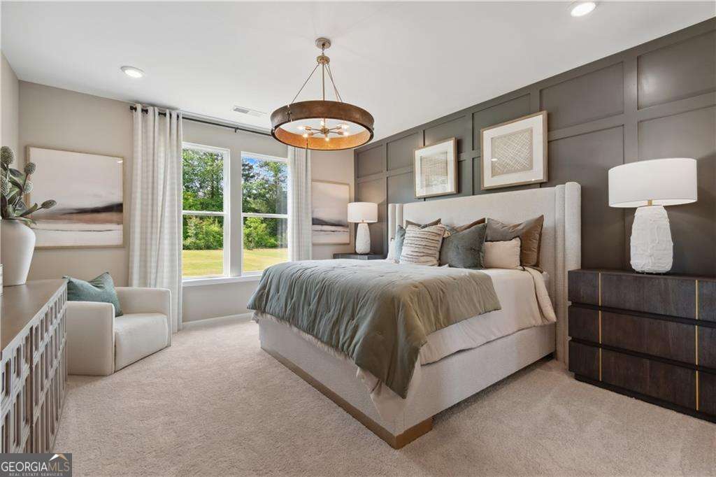 412 Hartsfield Road McDonough, GA 30253 - Photo 5 of 43 a spacious bedroom with a bed and a large window