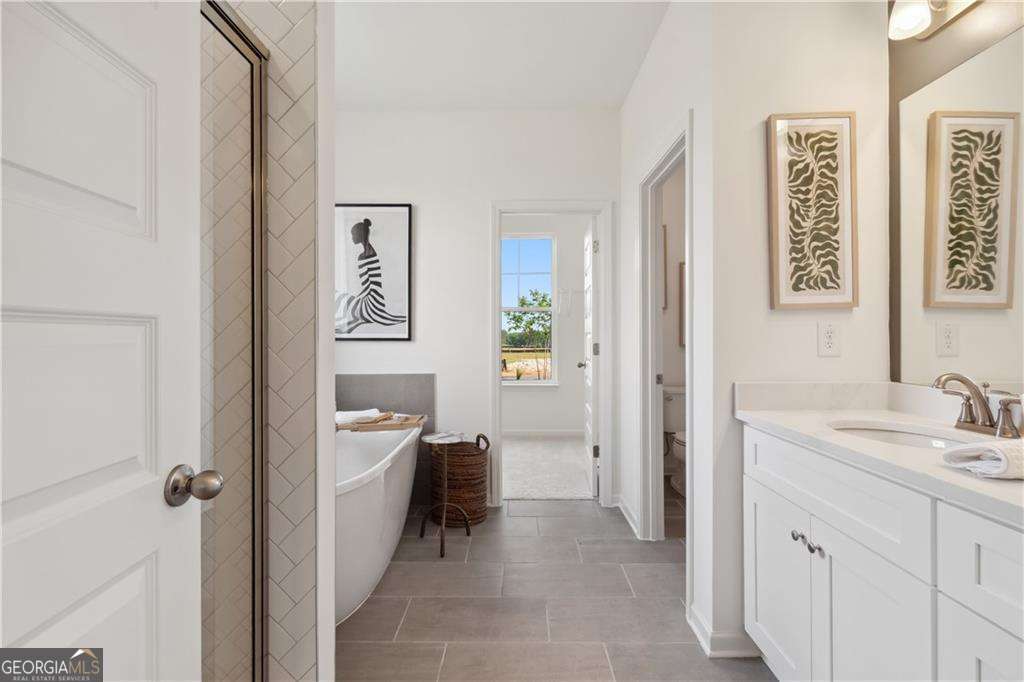412 Hartsfield Road McDonough, GA 30253 - Photo 6 of 43 a view of a bathroom with a sink and a mirror