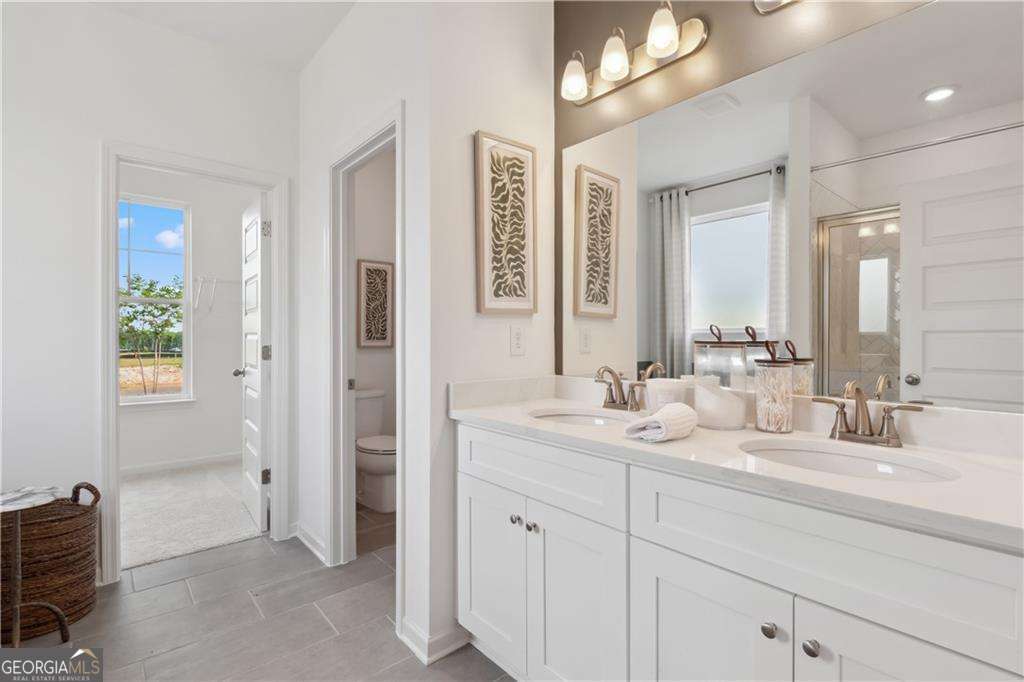 412 Hartsfield Road McDonough, GA 30253 - Photo 7 of 43 a bathroom with a double vanity sink and a mirror