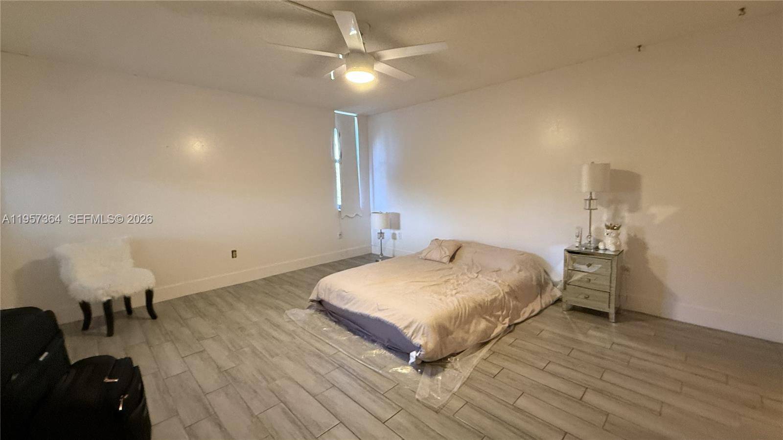6800 Cypress Road, Unit 501 Plantation, FL 33317 - Photo 14 of 40 a bedroom with a bed and ceiling fan
