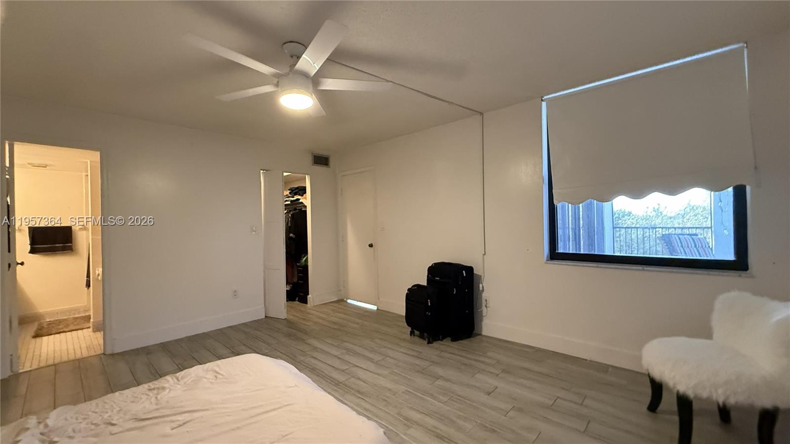 6800 Cypress Road, Unit 501 Plantation, FL 33317 - Photo 15 of 40 a view of an empty room with wooden floor and a ceiling fan