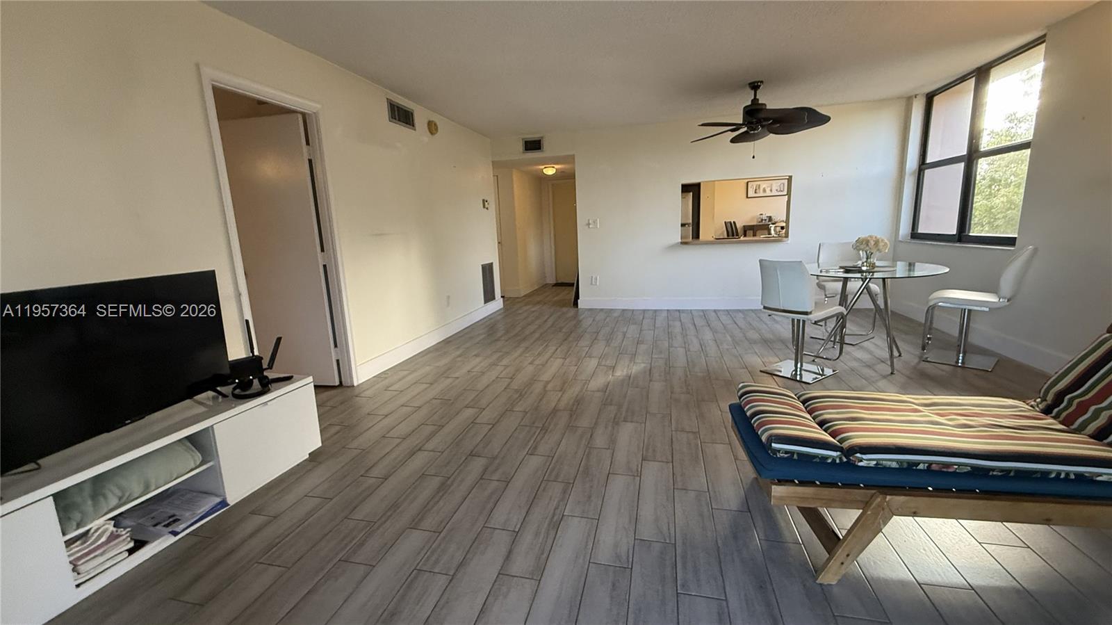 6800 Cypress Road, Unit 501 Plantation, FL 33317 - Photo 19 of 40 a living room with furniture and a flat screen tv