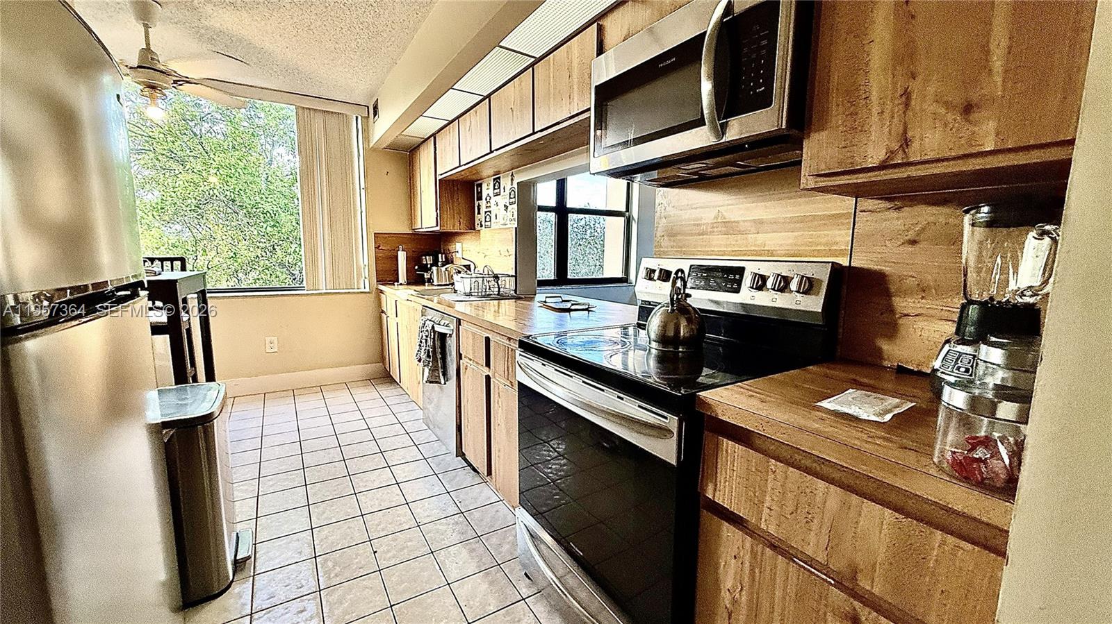 6800 Cypress Road, Unit 501 Plantation, FL 33317 - Photo 2 of 40 a kitchen with stainless steel appliances granite countertop a sink stove and refrigerator