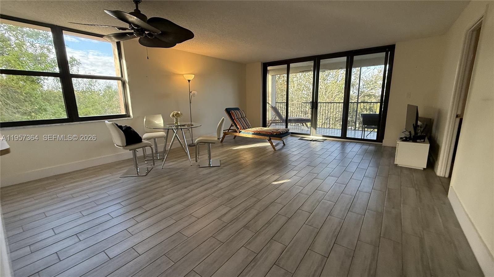 6800 Cypress Road, Unit 501 Plantation, FL 33317 - Photo 21 of 40 a view of room with wooden floor and windows