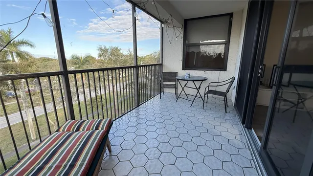a view of a balcony with furniture