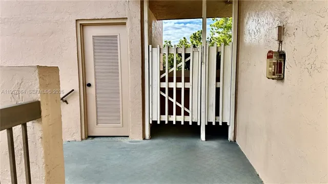 a view of a hallway with wooden floor and windows