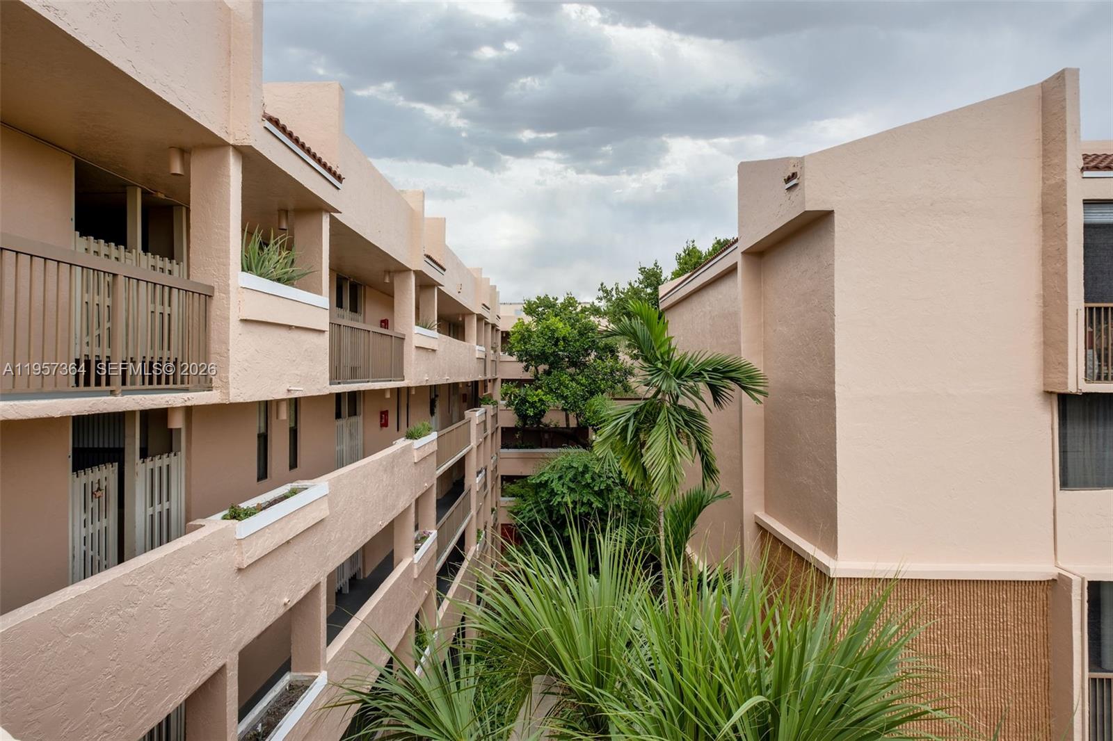 6800 Cypress Road, Unit 501 Plantation, FL 33317 - Photo 31 of 40 a balcony with plants and palm trees